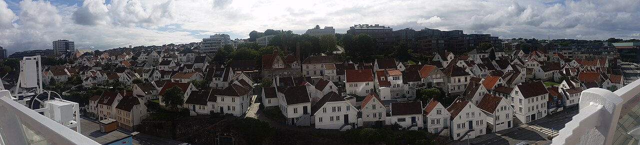 Panorama av Gamle Stavanger med hvite trehus langs havnepromenaden, sett fra sjøen